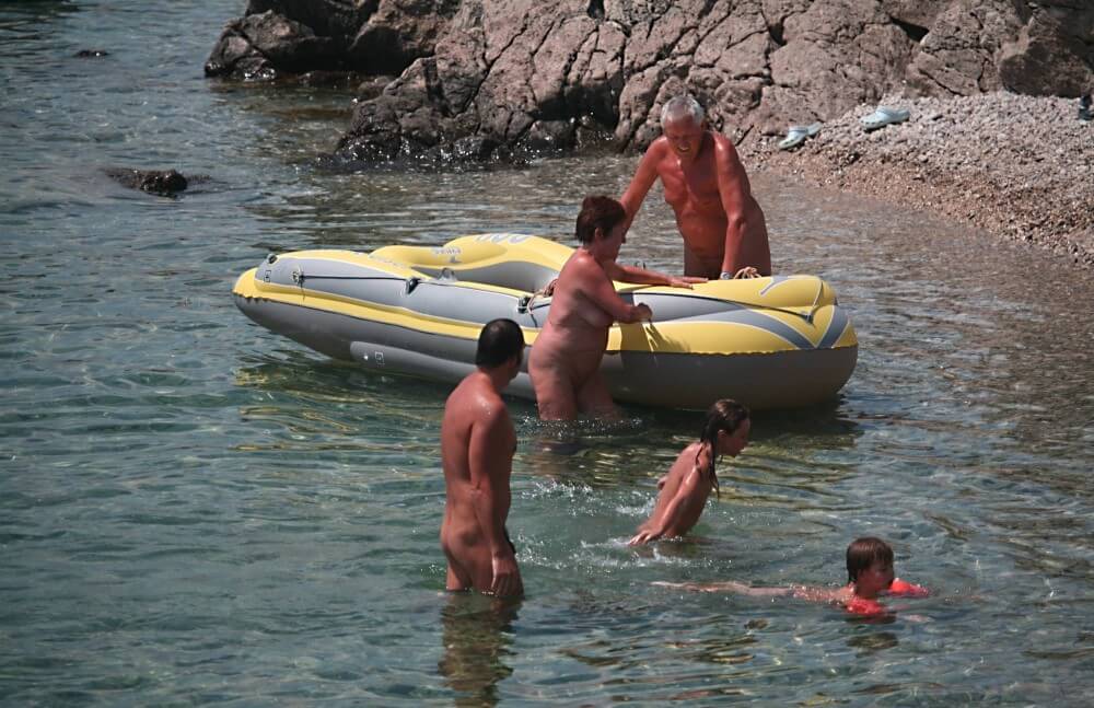Lone Nudist in Yellow Boat photos - Naturism helps accept everyones differences and unique qualities
